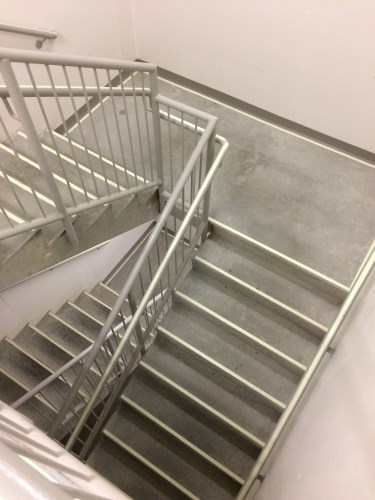 Staircase with aluminum strips on the stair nosings.